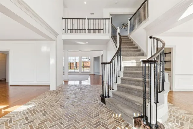 a view of staircase with white walls and windows