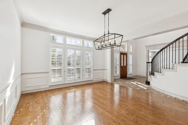 a front view of a house with a yard and potted plants