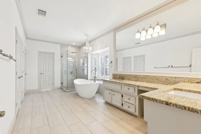 a spacious bathroom with a granite countertop sink and a mirror