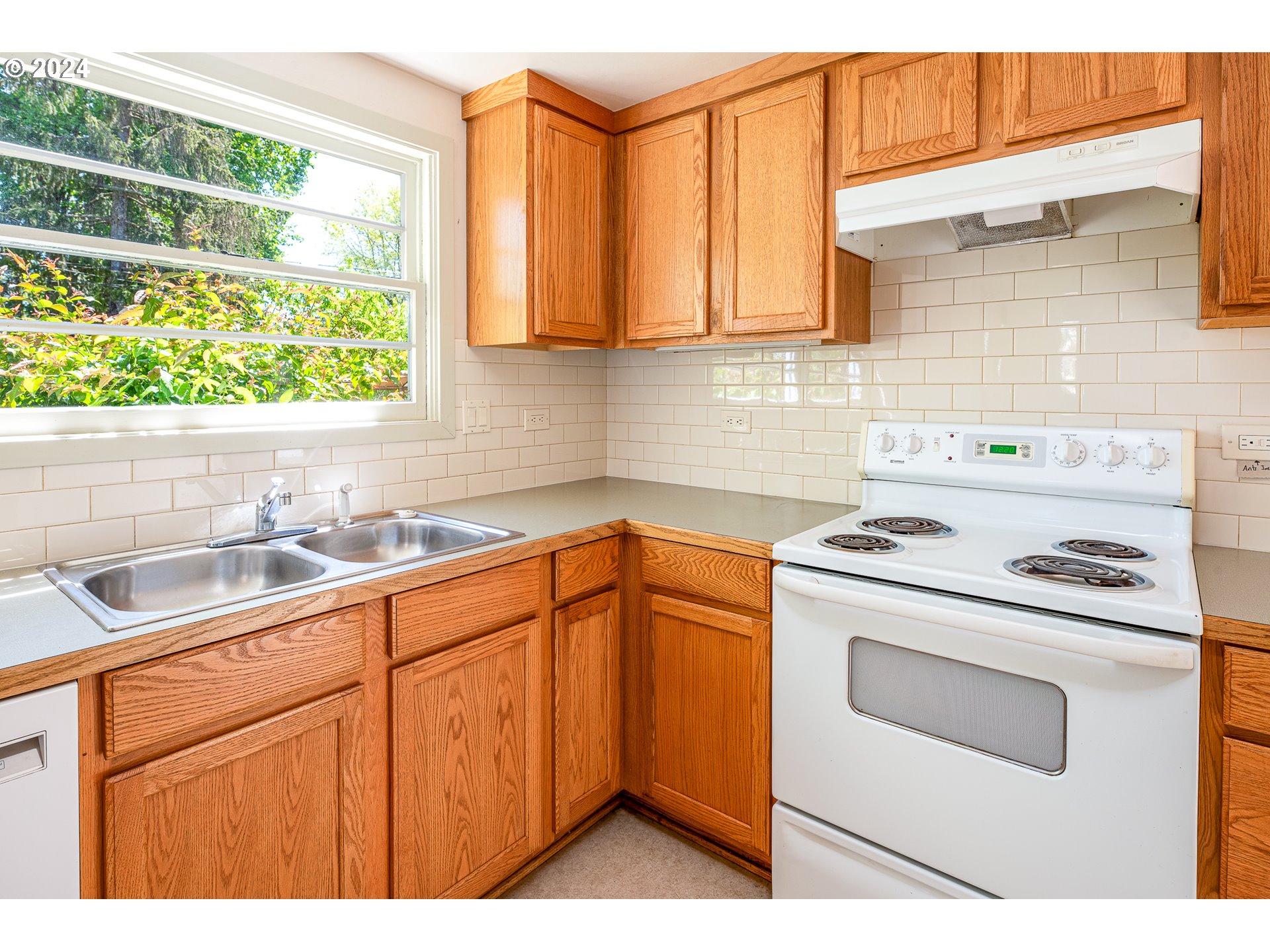 2915 Mill Street Eugene, OR 97405 - Photo 13 of 37 a kitchen with granite countertop a sink stainless steel appliances and cabinets