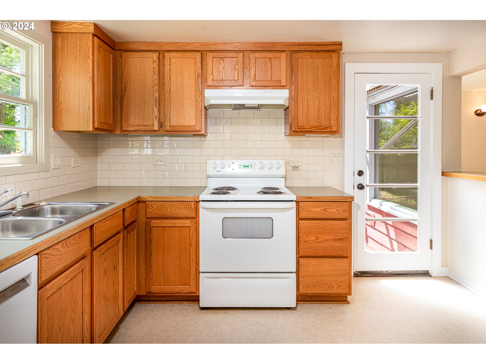 2915 Mill Street Eugene, OR 97405 - Photo 15 of 37 a kitchen with granite countertop white cabinets and white appliances