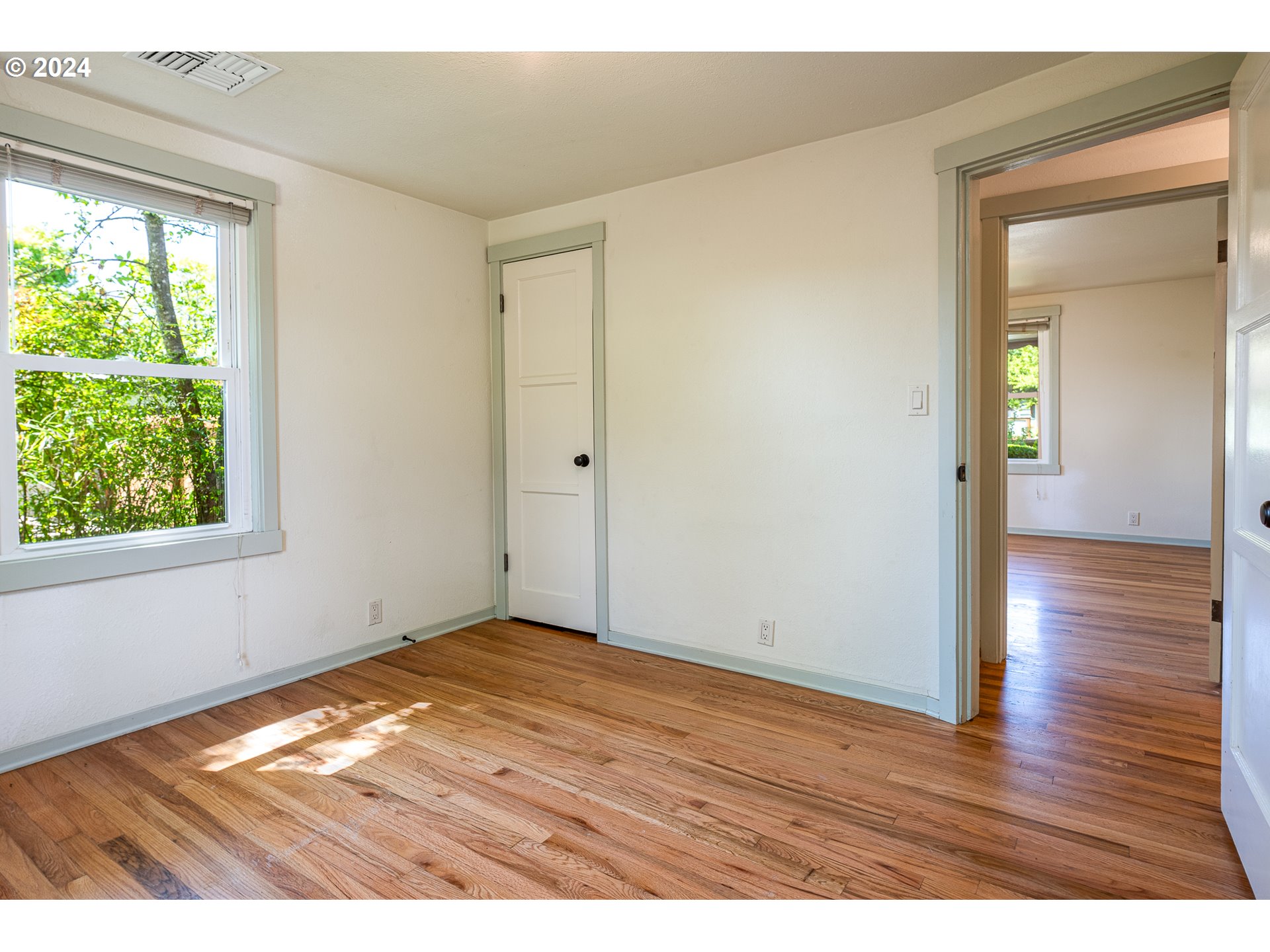 2915 Mill Street Eugene, OR 97405 - Photo 20 of 37 an empty room with wooden floor and windows