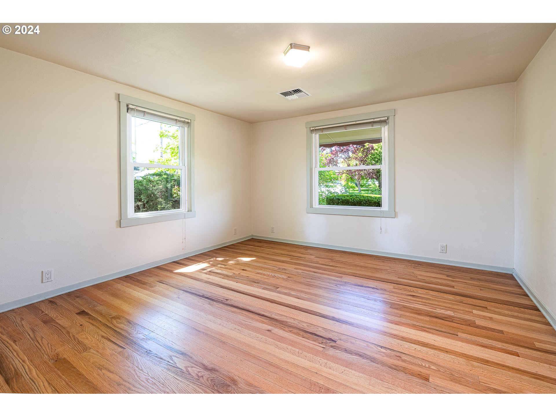2915 Mill Street Eugene, OR 97405 - Photo 22 of 37 an empty room with wooden floor and windows