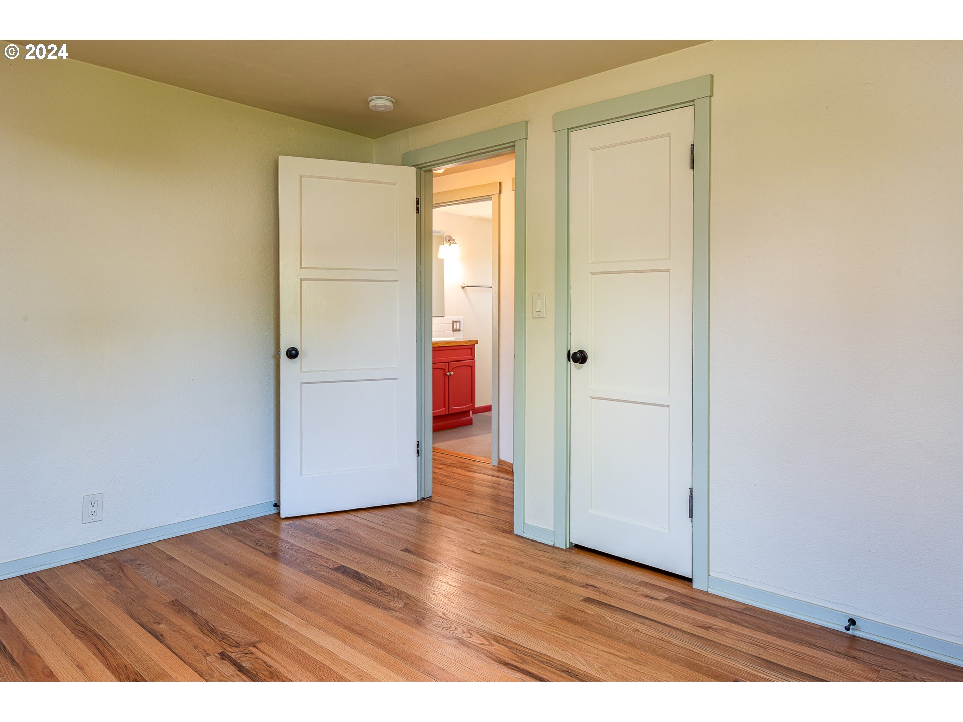2915 Mill Street Eugene, OR 97405 - Photo 23 of 37 an empty room with wooden floor and closet