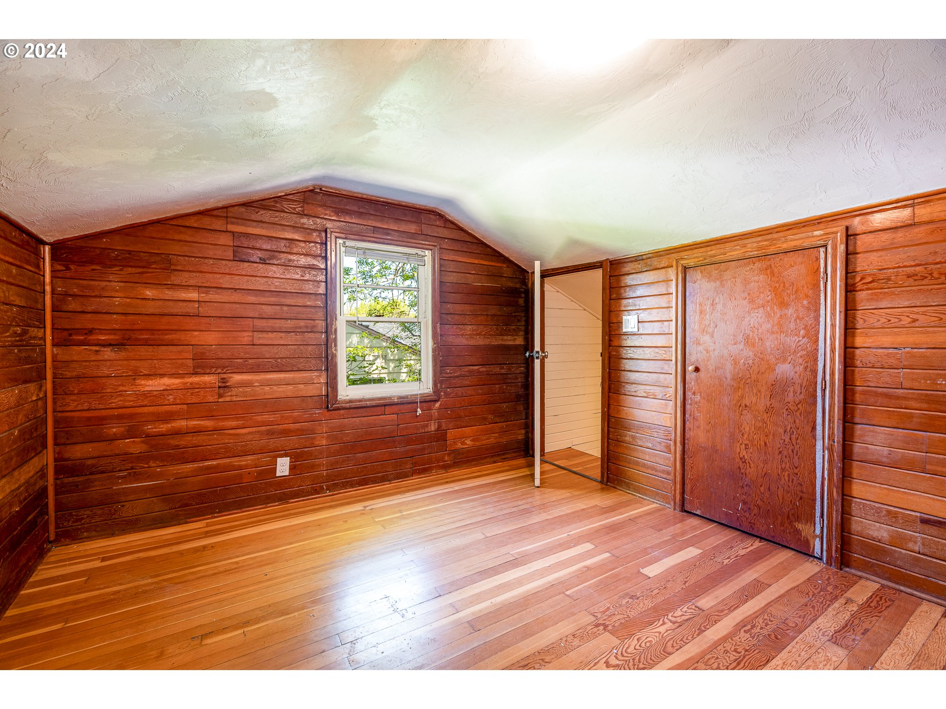 2915 Mill Street Eugene, OR 97405 - Photo 24 of 37 a view of an empty room and window with wooden floor