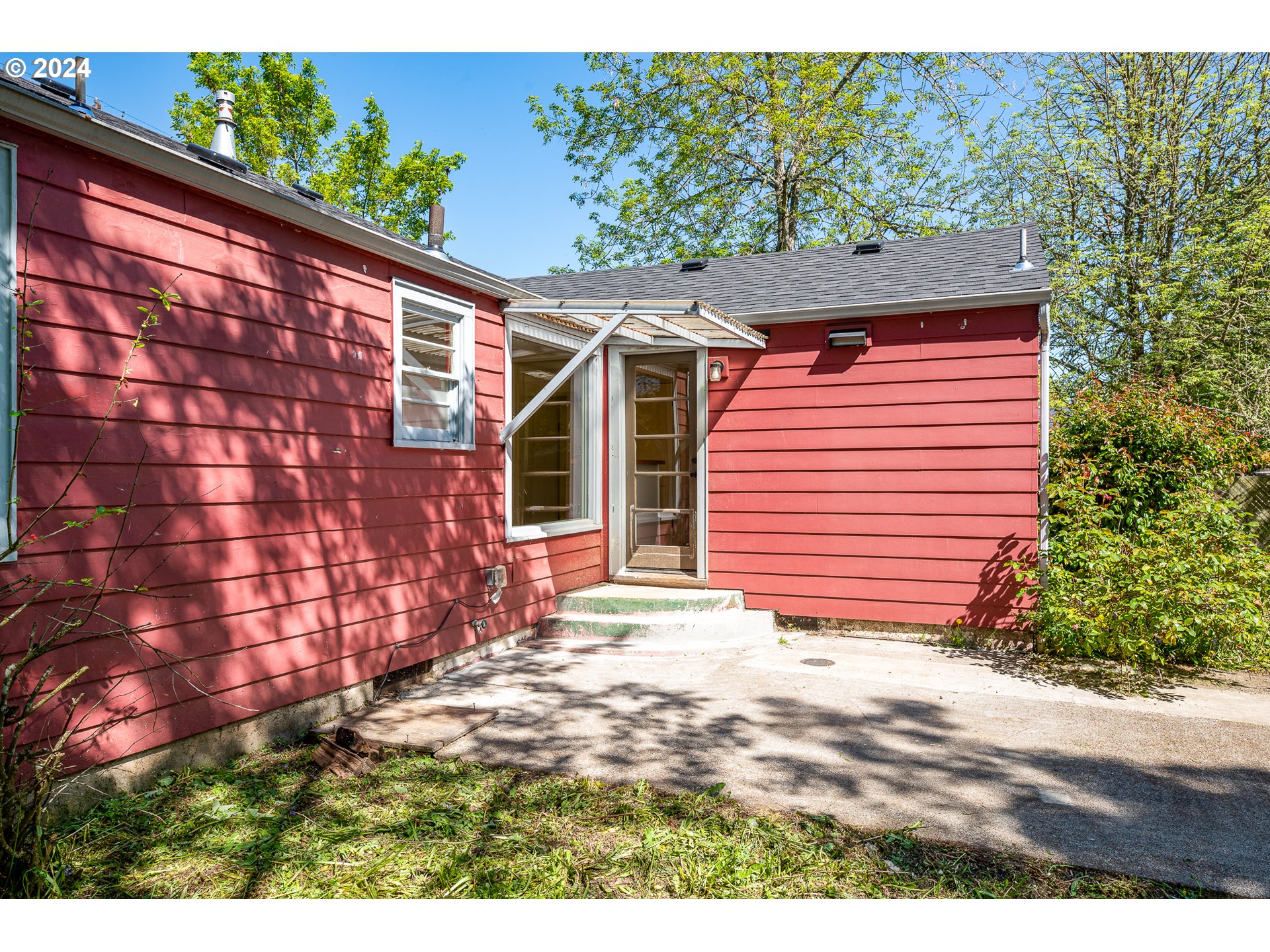2915 Mill Street Eugene, OR 97405 - Photo 25 of 37 a backyard of a house with a garden and barbeque oven
