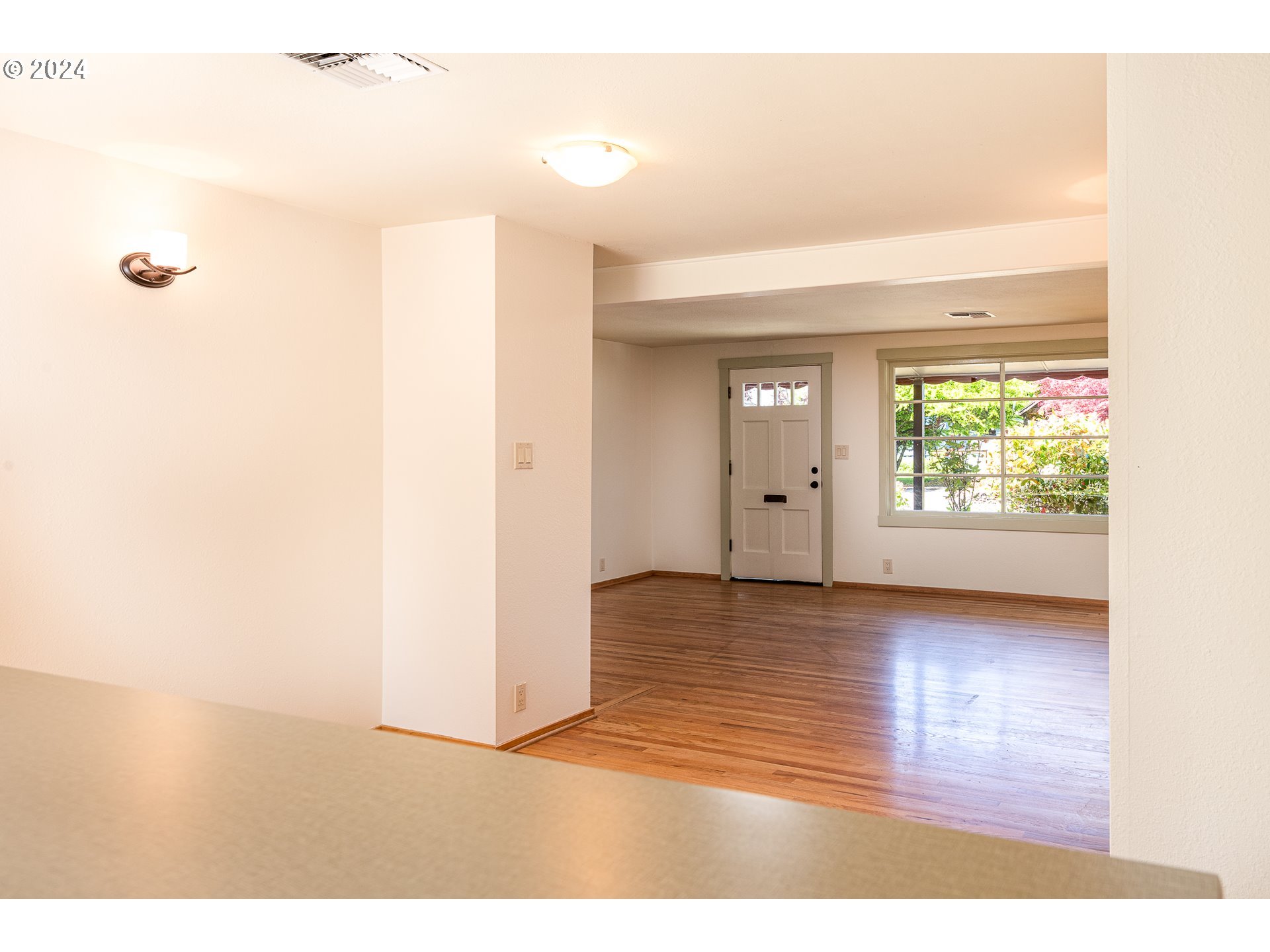 2915 Mill Street Eugene, OR 97405 - Photo 8 of 37 a view of an empty room with wooden floor and a window
