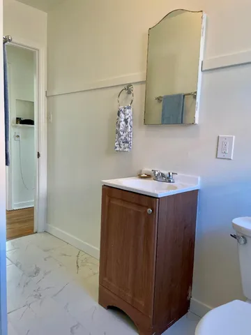 a bathroom with a sink vanity and mirror