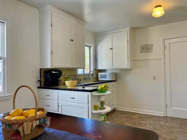 a kitchen with a sink a stove and cabinets