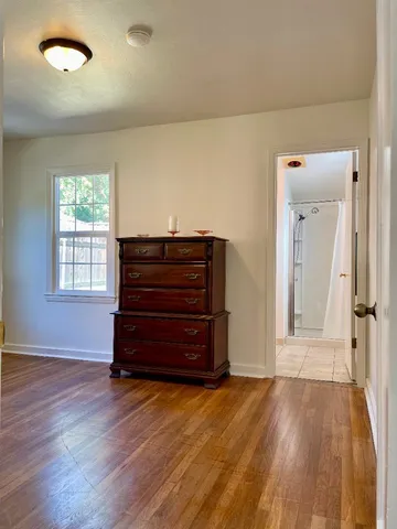a view of room with wooden floor and windows