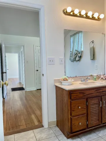 an empty room with window and wooden floor