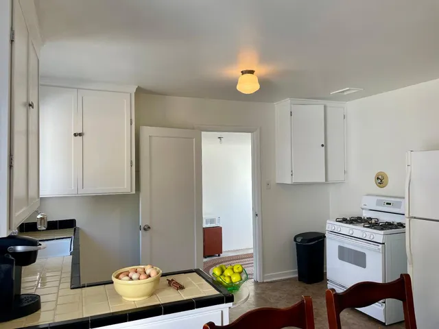 a living room with furniture and a painting