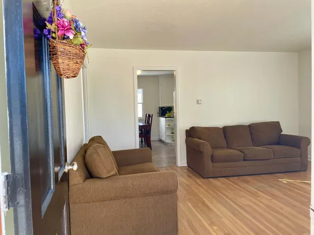a living room with furniture and flowers