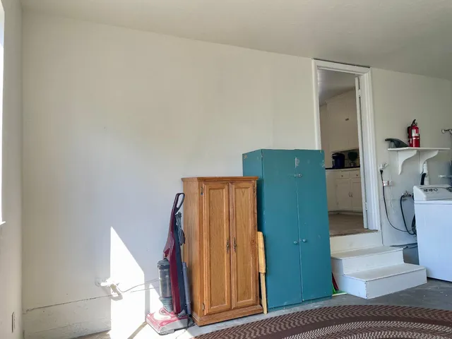 a bedroom with a bed and a mirror