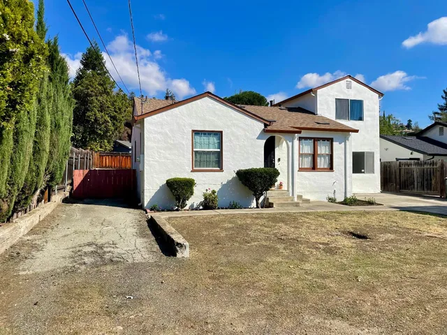 a backyard of a house with table and chairs