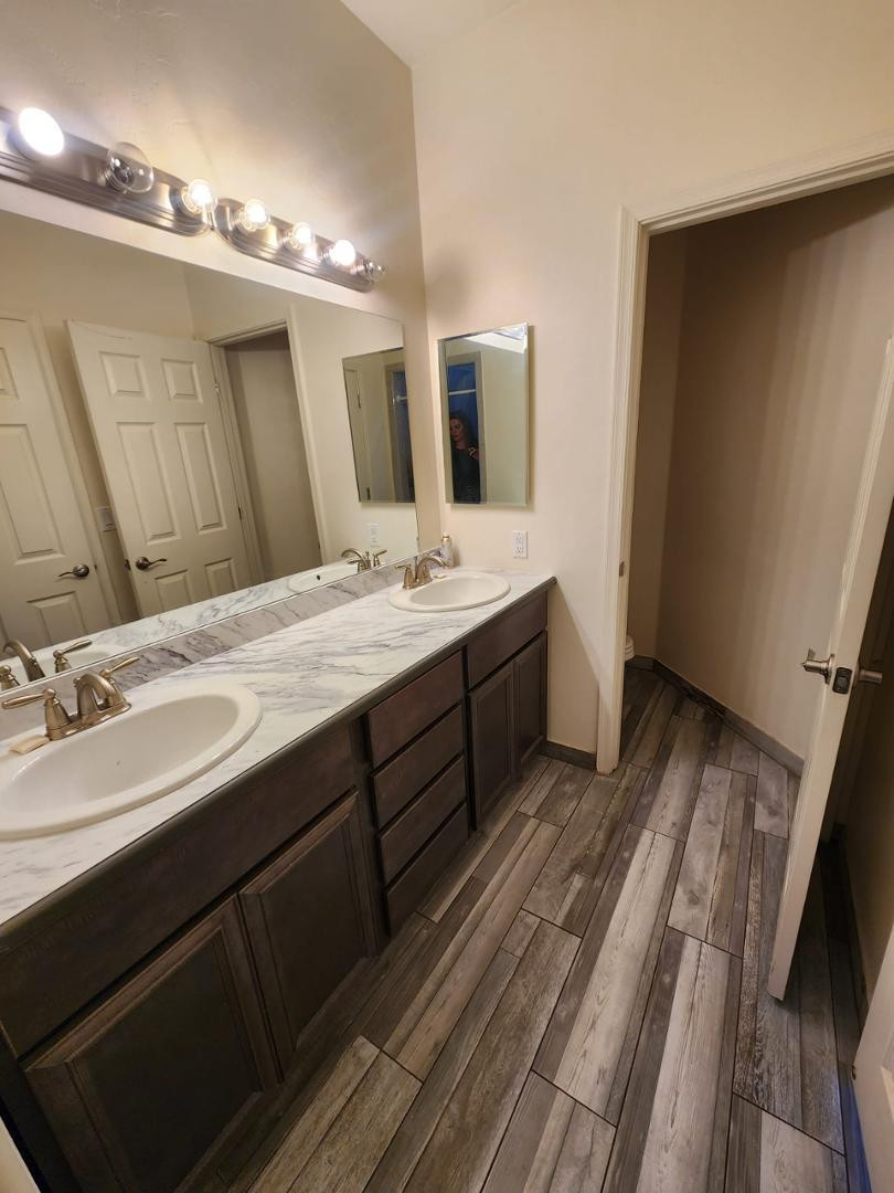 3641 Camino Del Rancho Douglas, AZ 85607 - Photo 14 of 20 a bathroom with a double vanity sink and mirror