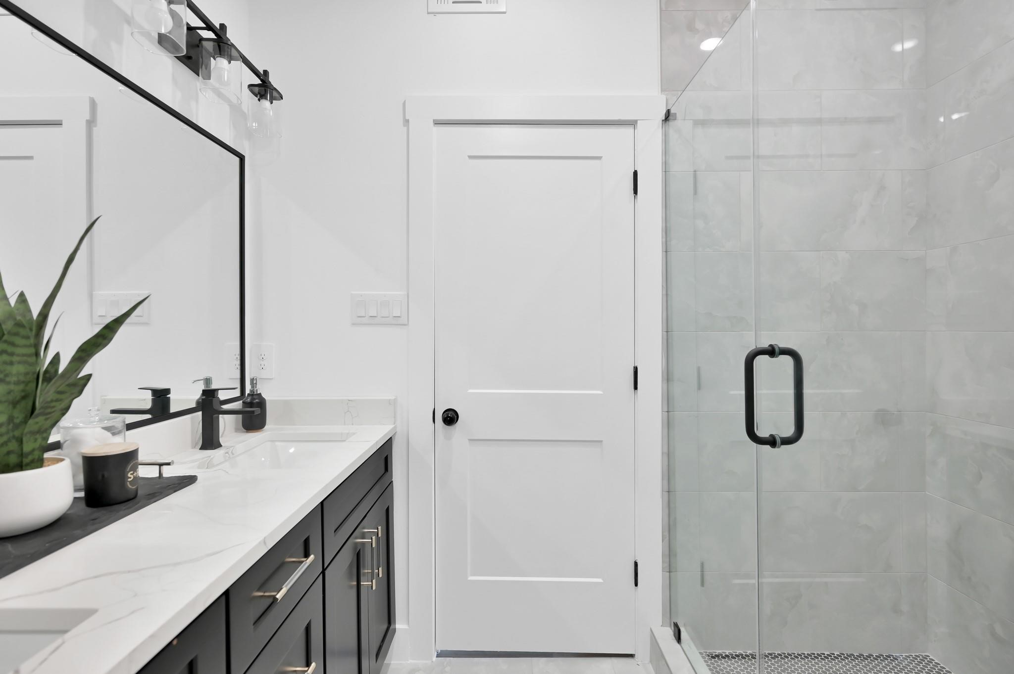 8017 A Cora Street Houston, TX 77088 - Photo 13 of 29 a bathroom with a double vanity sink a mirror and shower