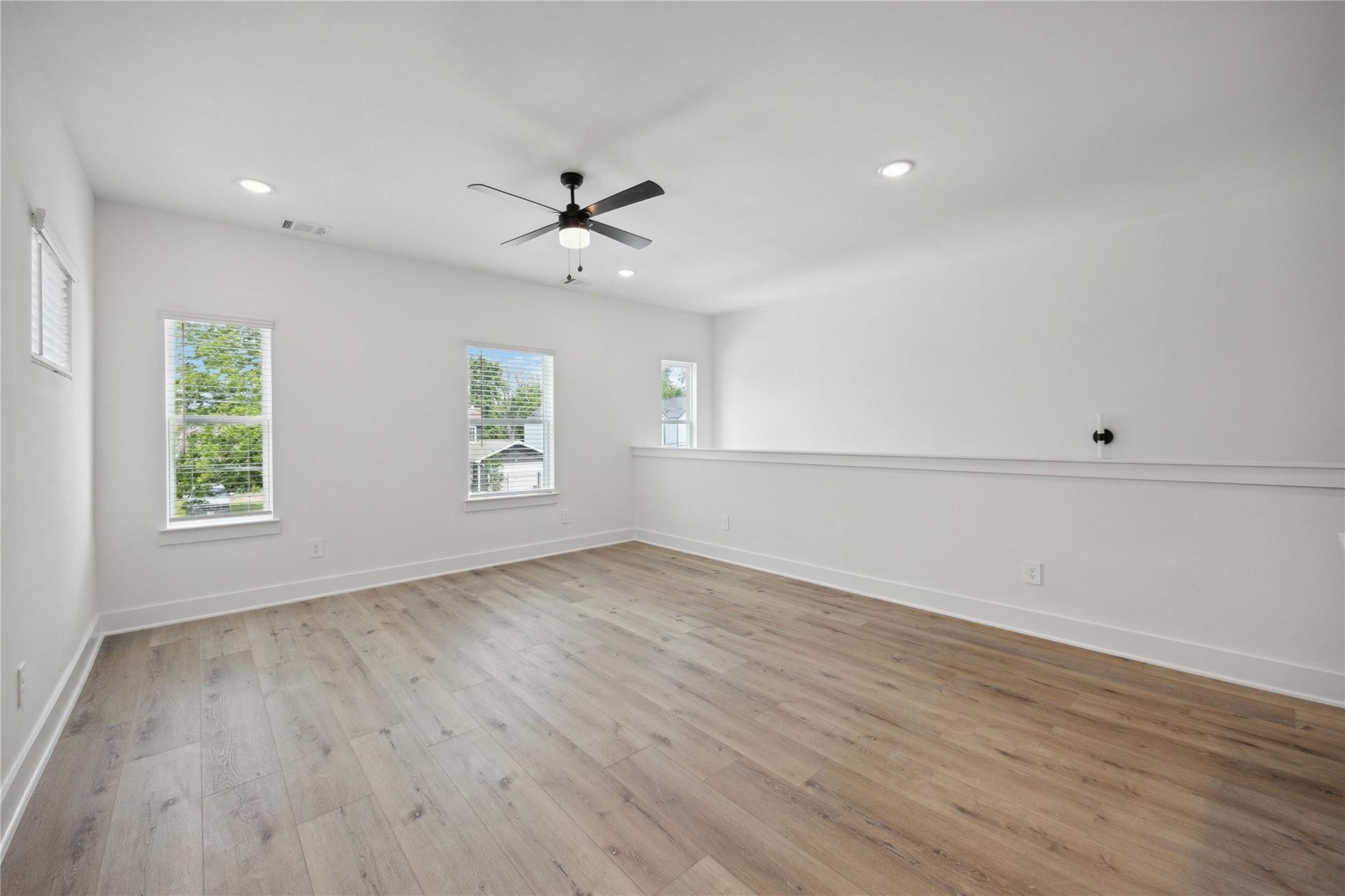 8017 A Cora Street Houston, TX 77088 - Photo 19 of 29 wooden floor in an empty room with a window