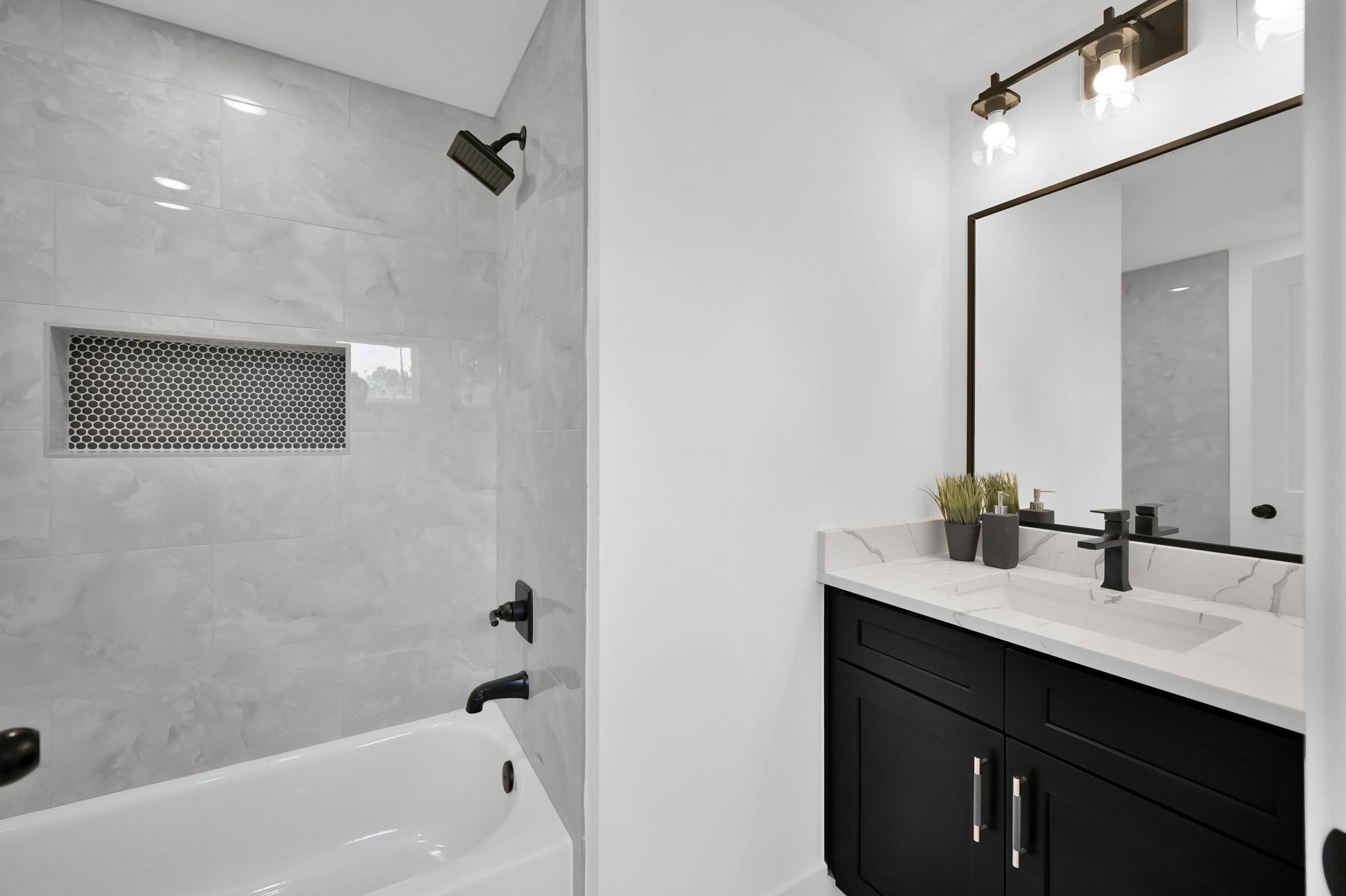 8017 A Cora Street Houston, TX 77088 - Photo 23 of 29 a bathroom with a sink and a bathtub