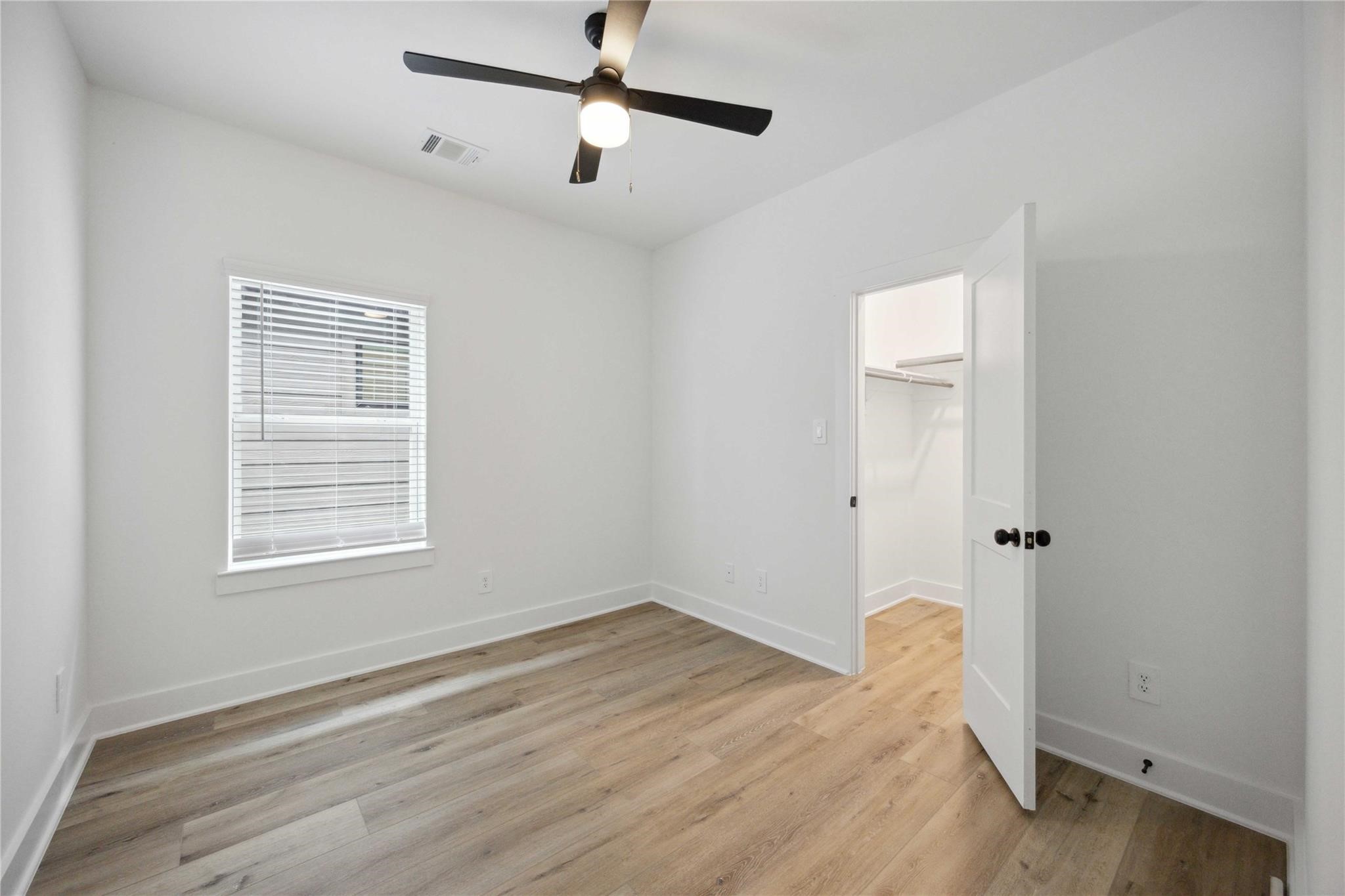 8017 A Cora Street Houston, TX 77088 - Photo 24 of 29 wooden floor in an empty room with a window