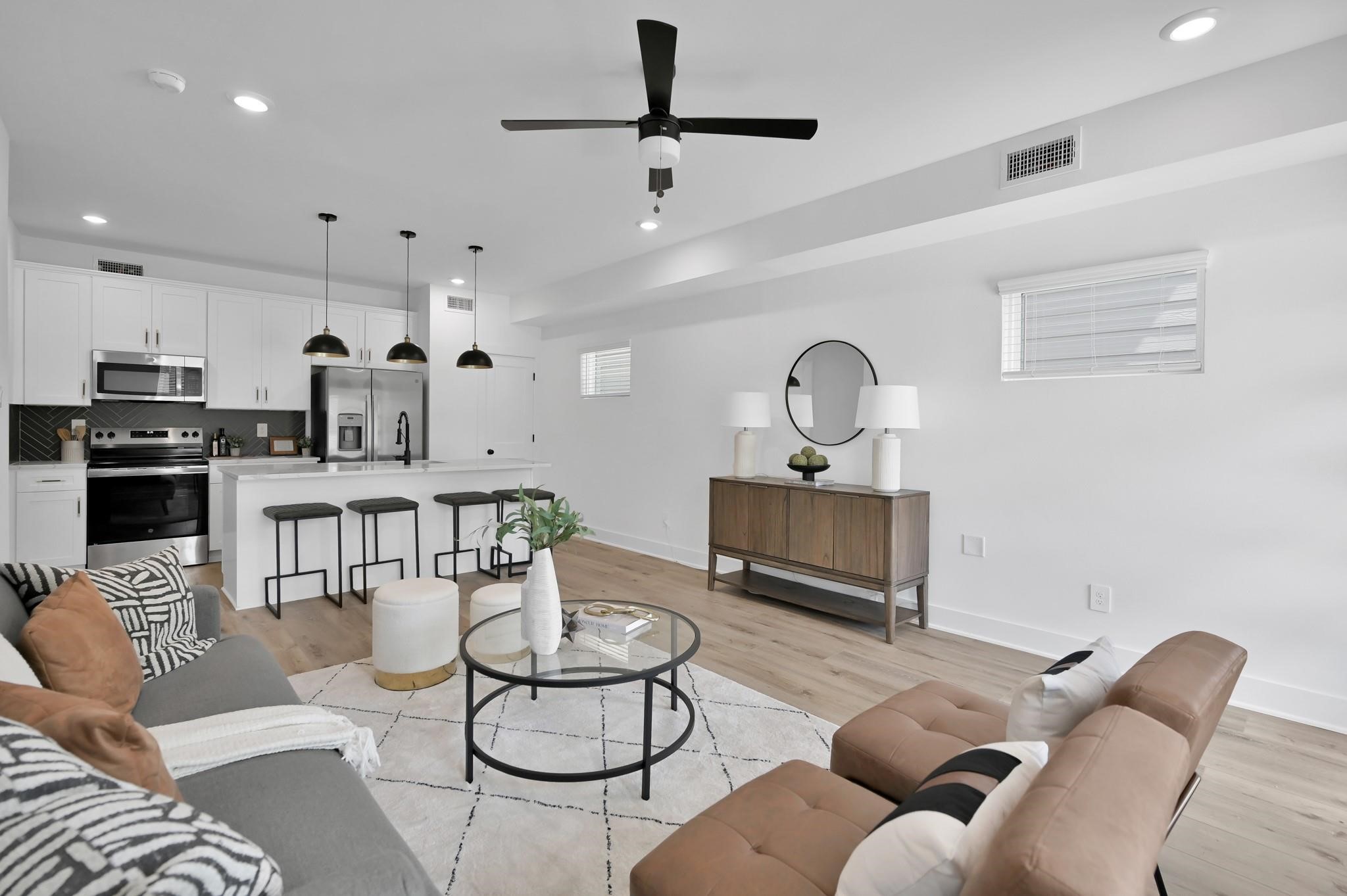 8017 A Cora Street Houston, TX 77088 - Photo 5 of 29 a living room with furniture a view of kitchen and a chandelier