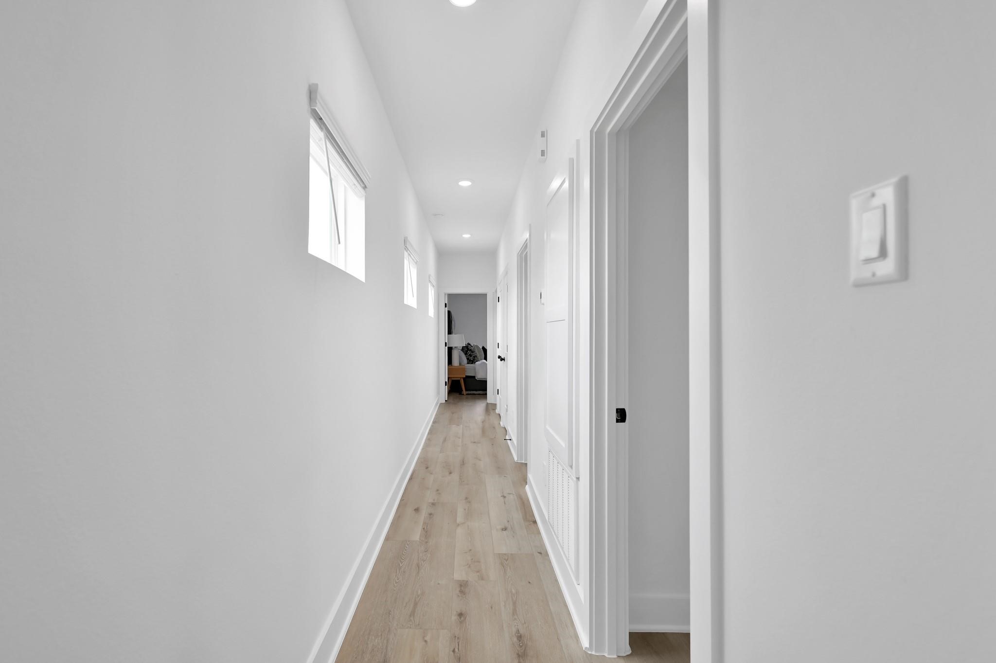 8017 A Cora Street Houston, TX 77088 - Photo 9 of 29 a view of a hallway with wooden floor and a window