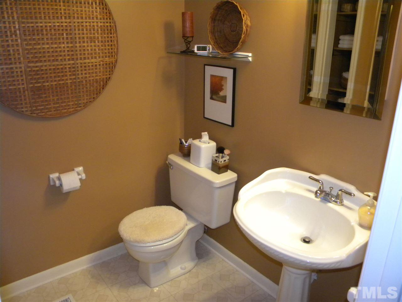 6500 Keystone Drive Raleigh, NC 27612 - Photo 13 of 15 a bathroom with a sink mirror and toilet