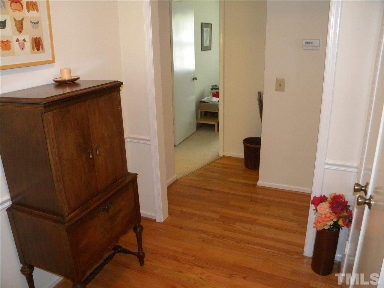 6500 Keystone Drive Raleigh, NC 27612 - Photo 3 of 15 a view of a hallway with wooden floor and stairs