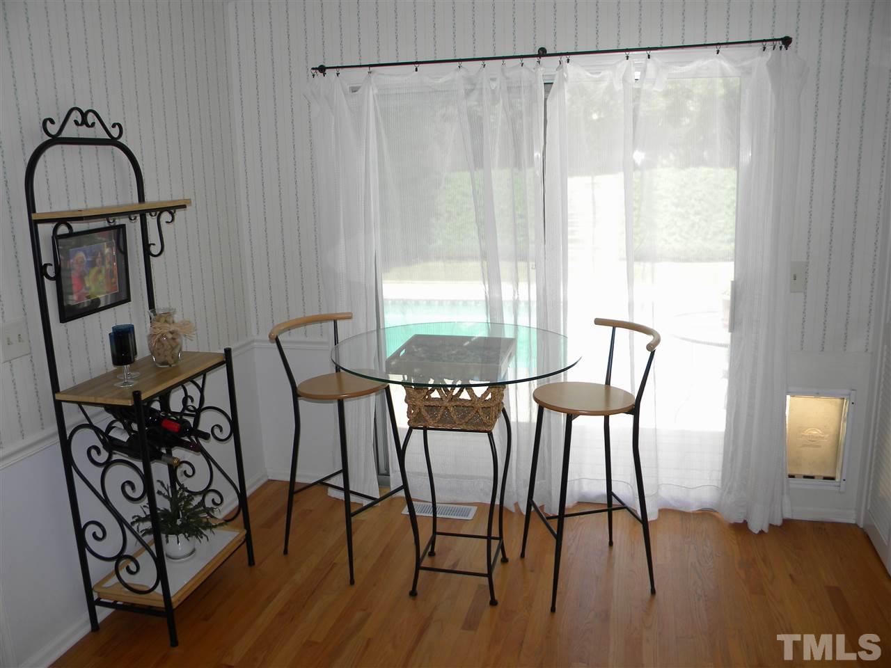 6500 Keystone Drive Raleigh, NC 27612 - Photo 7 of 15 a view of a dining room with furniture and wooden floor