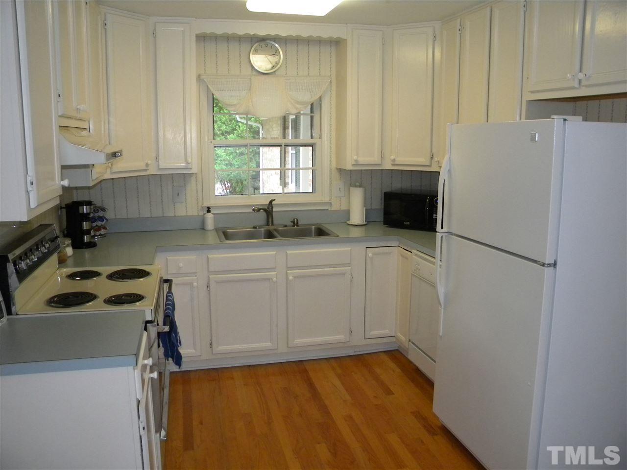6500 Keystone Drive Raleigh, NC 27612 - Photo 8 of 15 a kitchen with a refrigerator a sink and cabinets
