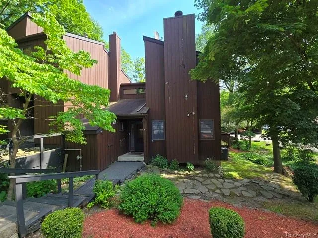 front view of a house with a tree