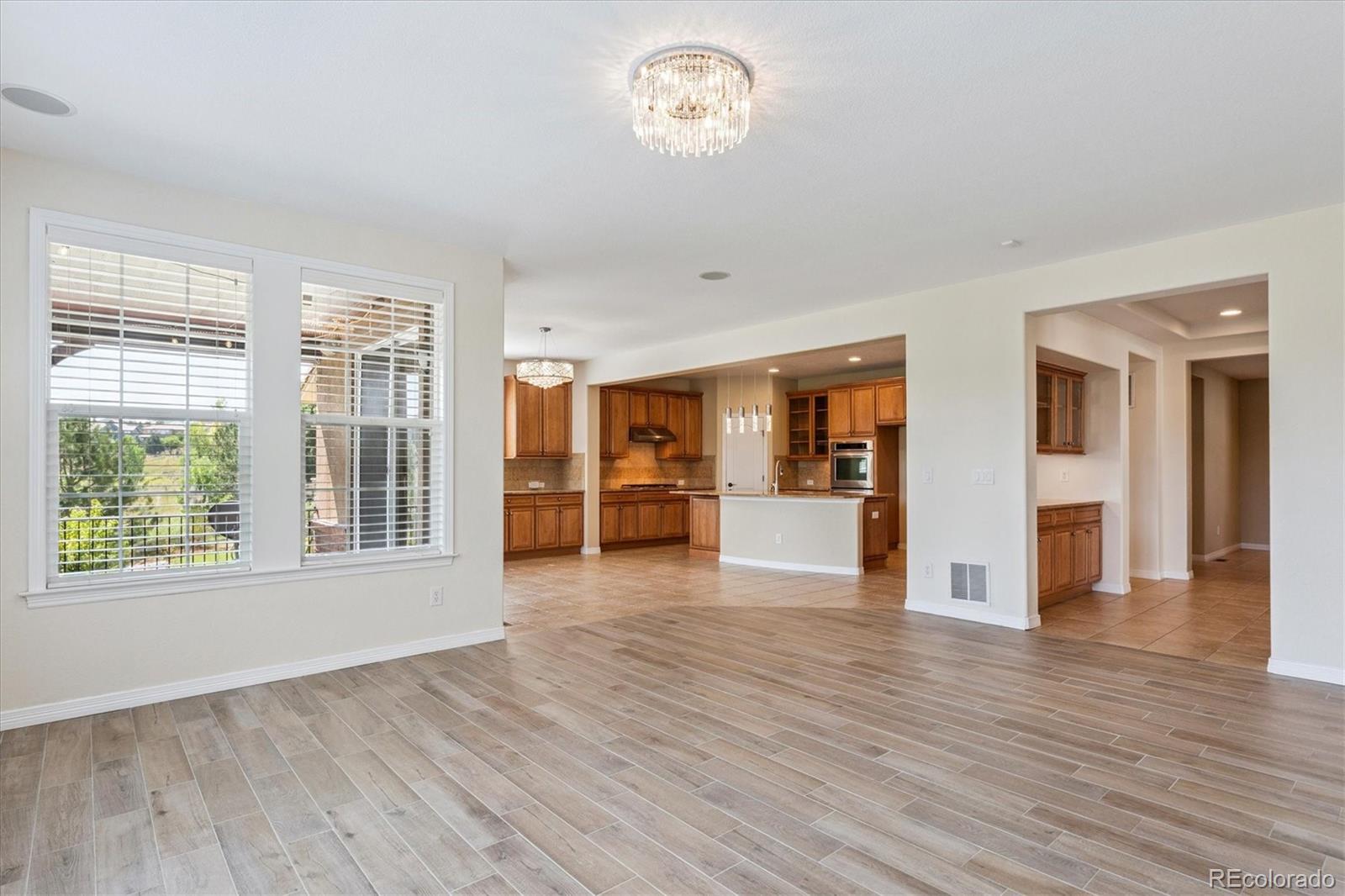 10426 Willowwisp Way Highlands Ranch, CO 80126 - Photo 13 of 47 a view of an empty room with wooden floor and a window