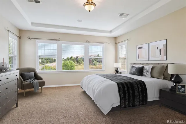 a bed room with a bed and chair