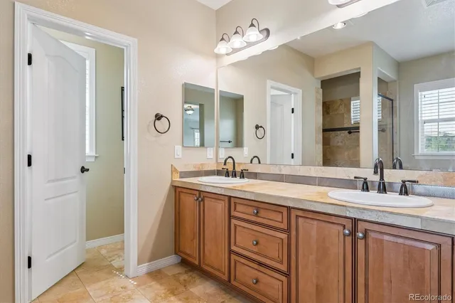 a bathroom with a double vanity sink and a mirror