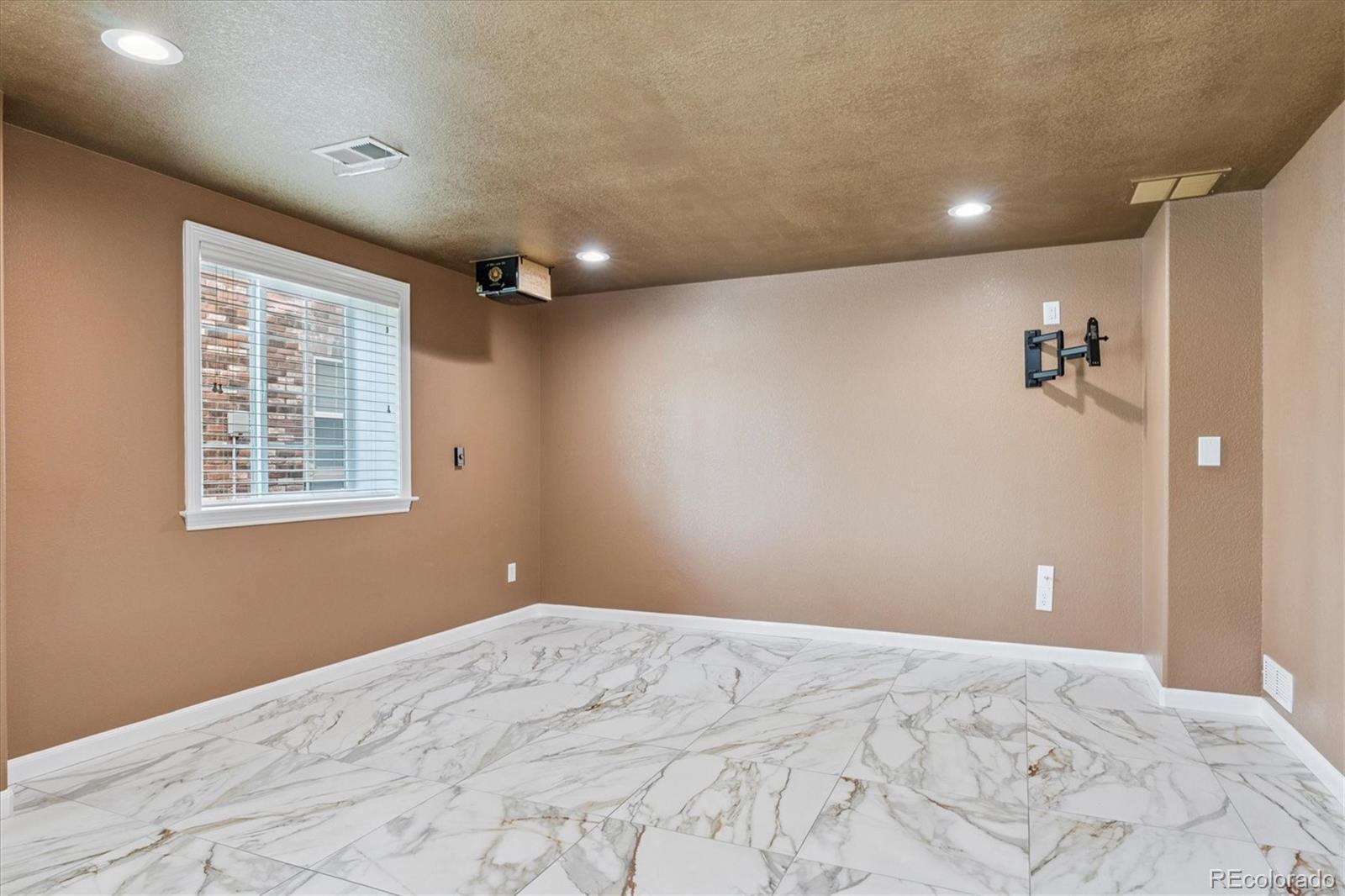 10426 Willowwisp Way Highlands Ranch, CO 80126 - Photo 34 of 47 a view of a livingroom with a ceiling fan and window