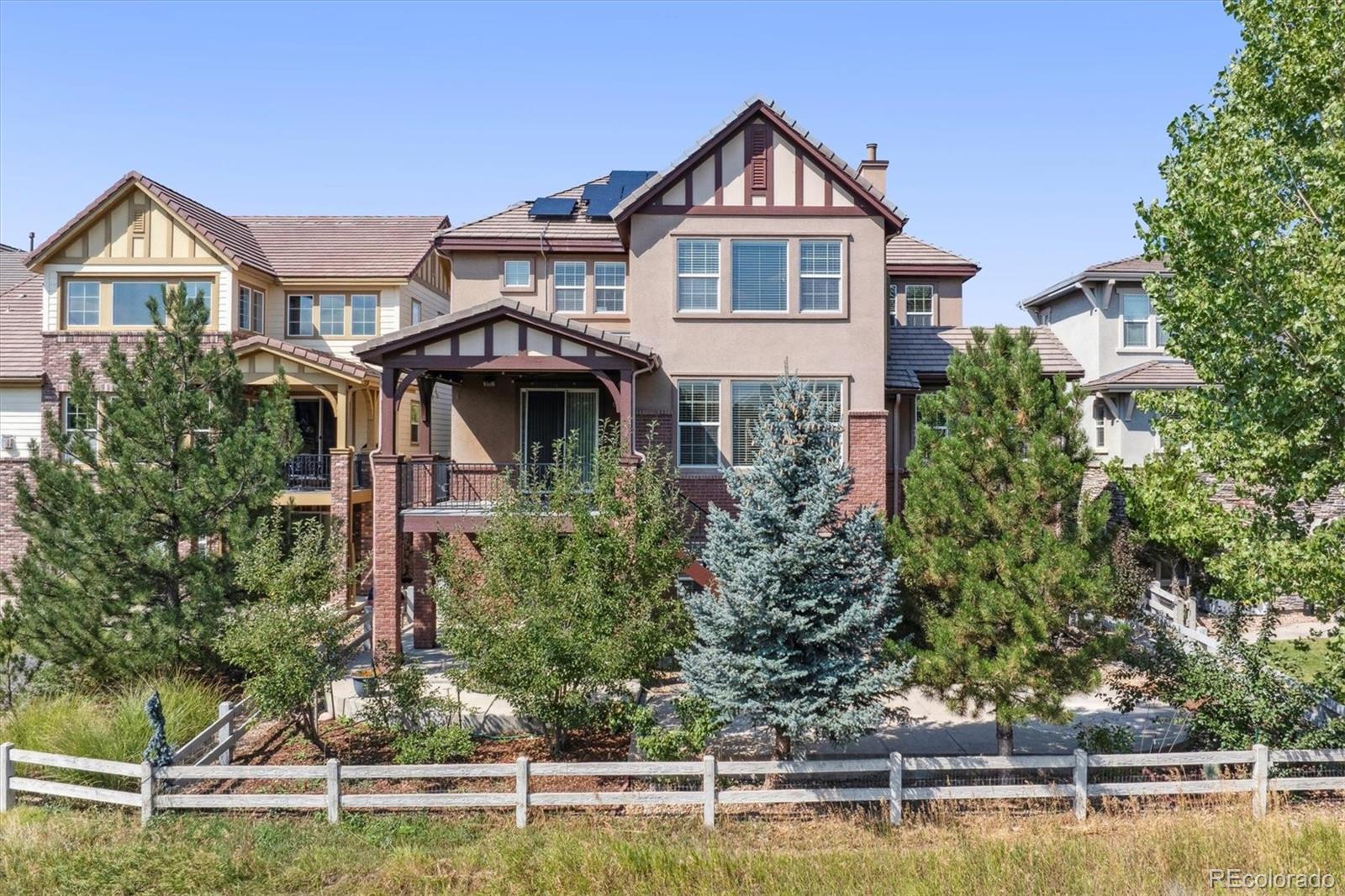 10426 Willowwisp Way Highlands Ranch, CO 80126 - Photo 37 of 47 a front view of a house with a yard and potted plants