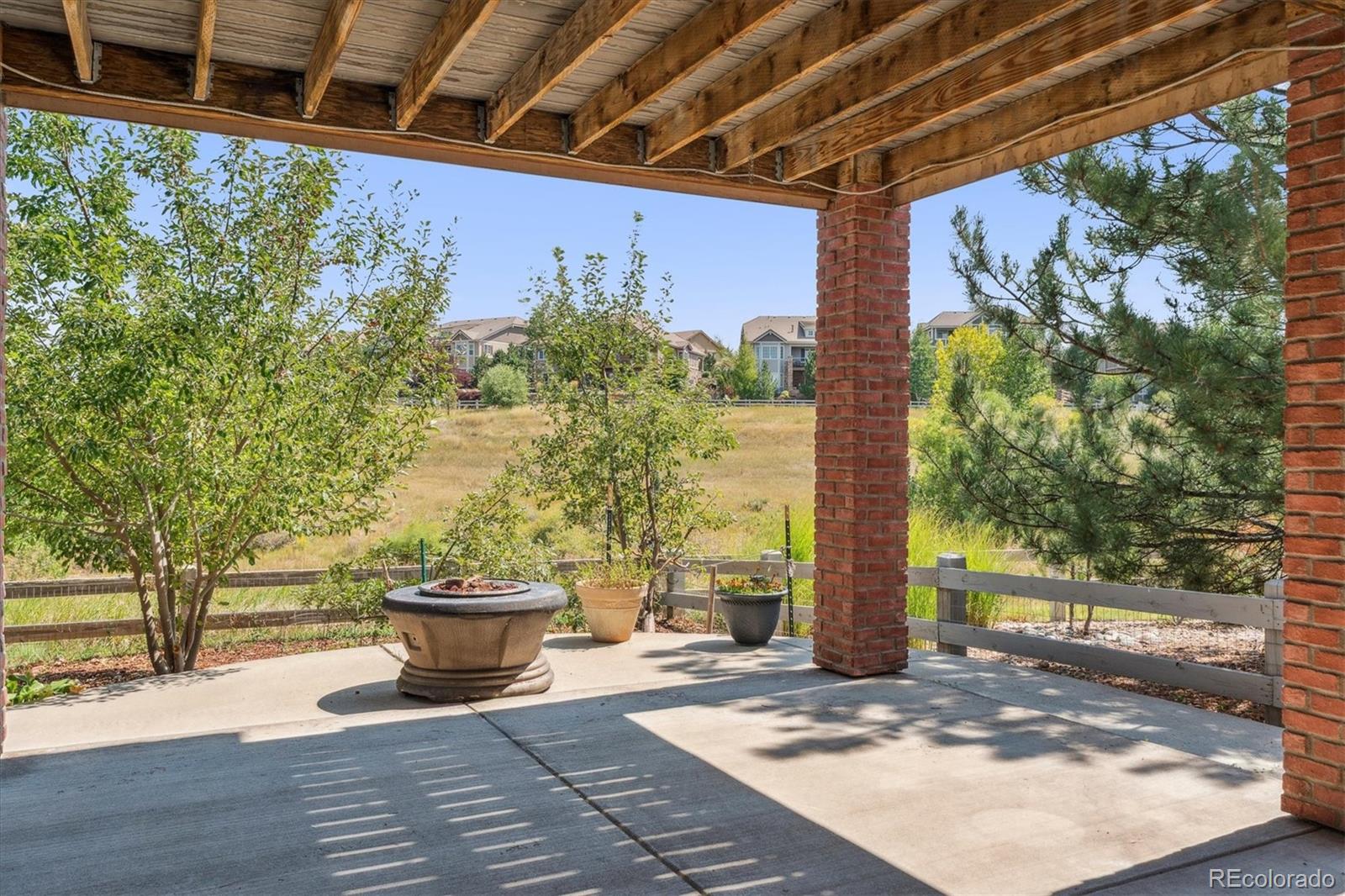10426 Willowwisp Way Highlands Ranch, CO 80126 - Photo 39 of 47 a view of a porch with a potted plant and floor to ceiling window
