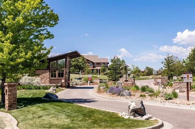 a swimming pool view with a seating space and a garden view