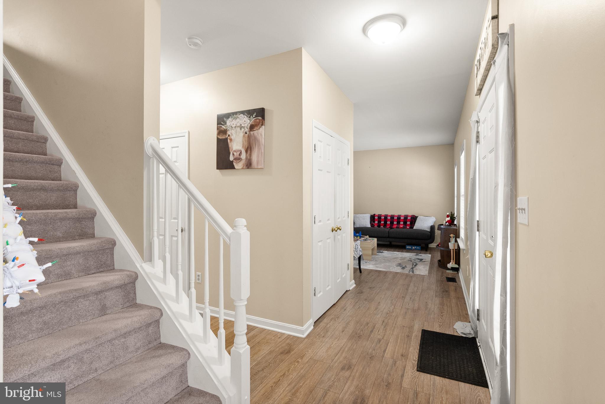 10757 Shenandoah Path Catlett, VA 20119 - Photo 16 of 55 a view of a hallway to a livingroom with wooden floor and staircase