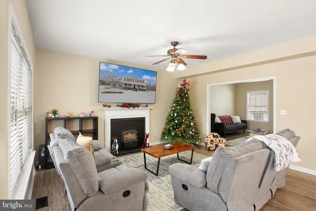a living room with furniture kitchen view and a chandelier