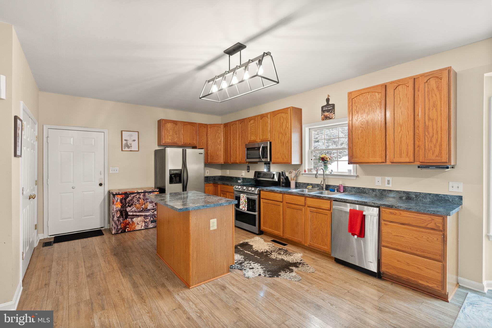 10757 Shenandoah Path Catlett, VA 20119 - Photo 28 of 55 a kitchen with kitchen island granite countertop wooden floors and stainless steel appliances