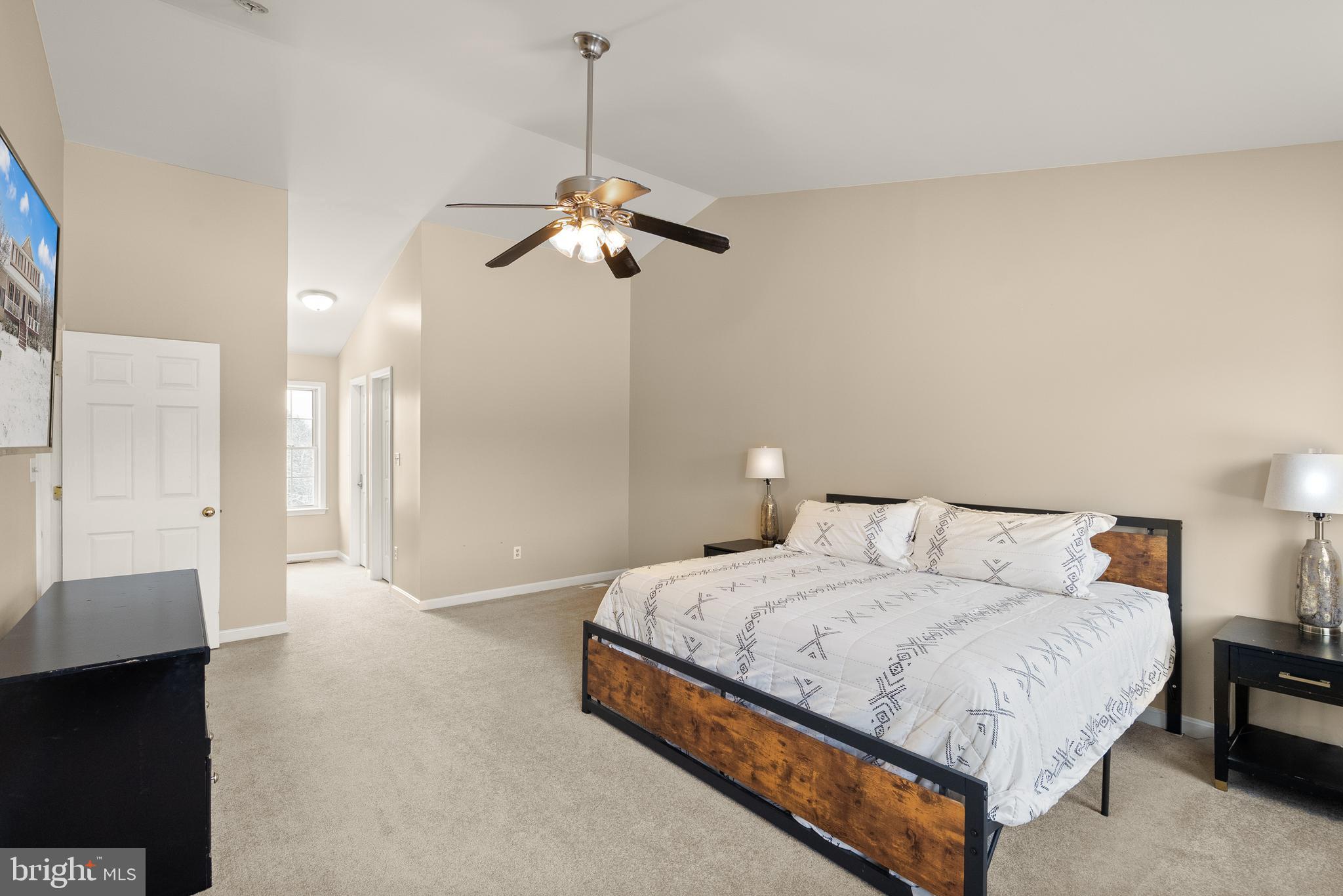 10757 Shenandoah Path Catlett, VA 20119 - Photo 36 of 55 a bedroom with a bed ceiling fan and a wooden floor