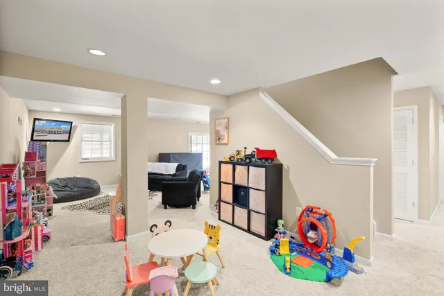 a living room with furniture and a gym equipment