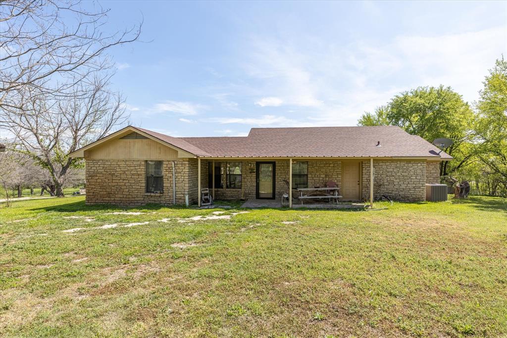 9885 County Road 270 Hico, TX 76457 - Photo 14 of 40 a front view of a house with a yard and garage