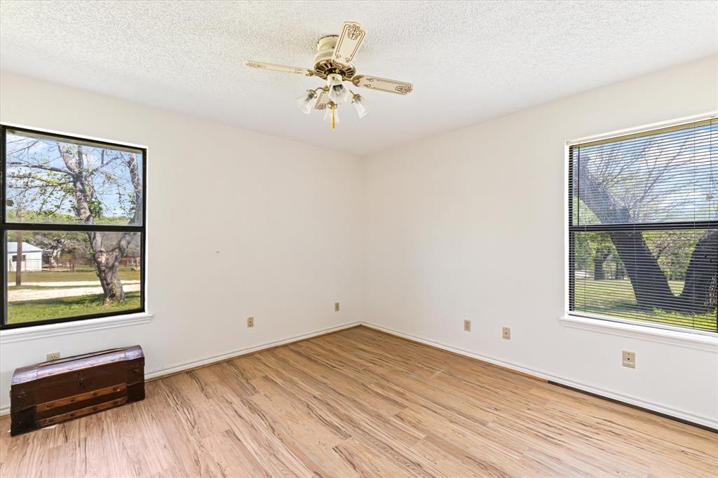 9885 County Road 270 Hico, TX 76457 - Photo 24 of 40 a view of empty room with wooden floor and fan