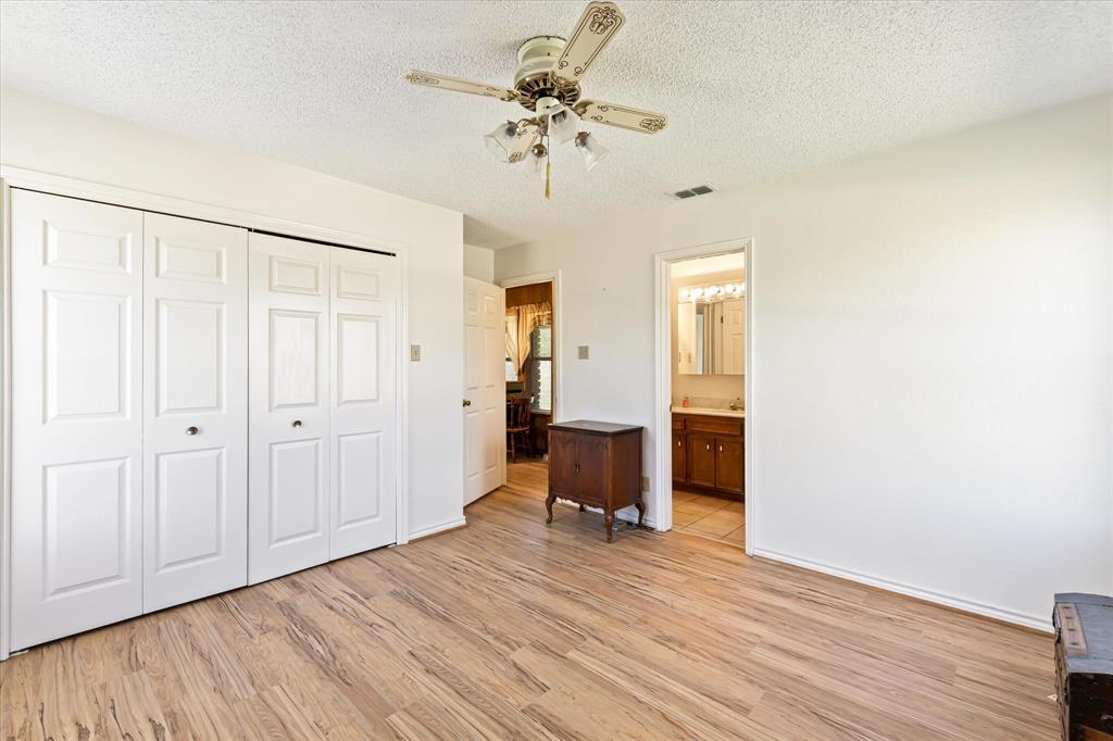 9885 County Road 270 Hico, TX 76457 - Photo 25 of 40 a view of a room with wooden floor and a ceiling fan
