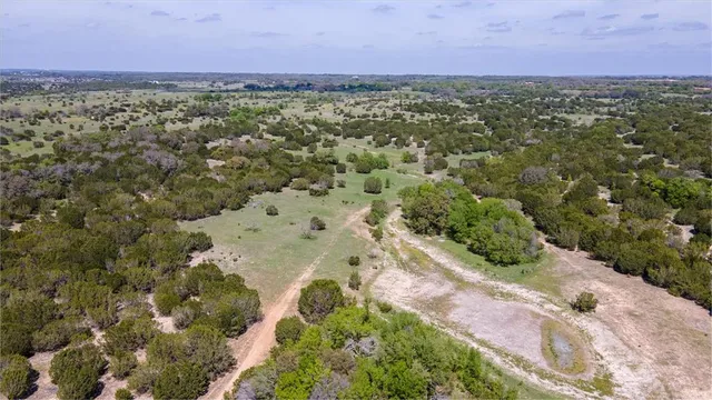 an aerial view of a houses with a yard