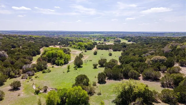 an aerial view of a houses with a yard