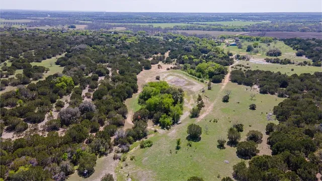 an aerial view of a houses with a yard