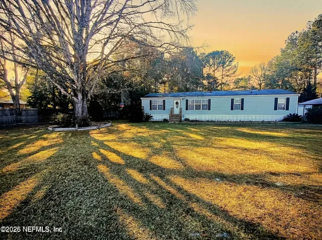a view of a house with swimming pool and sitting area